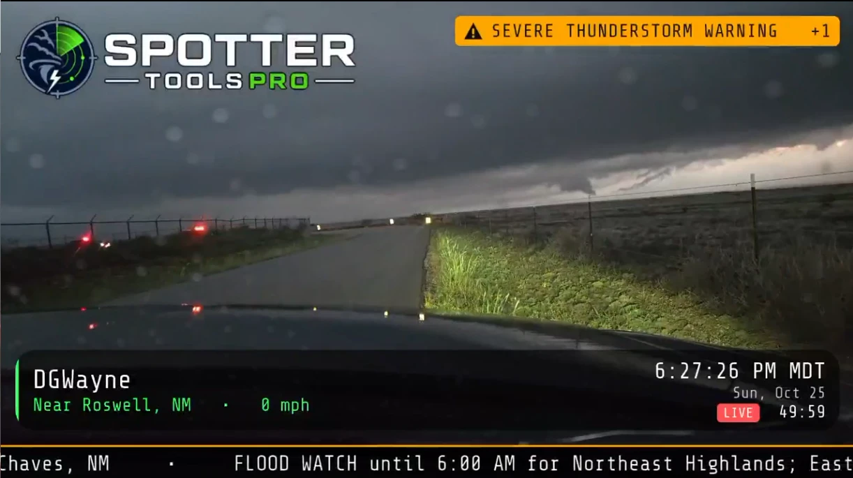 Live stream under a dark storm with rain on the windshield, still in focus on the storm